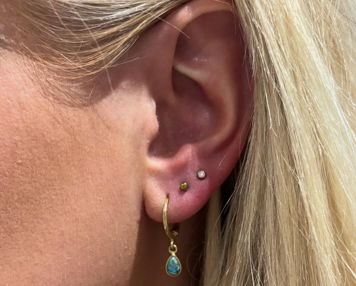 Pierced ear with gold jewellery